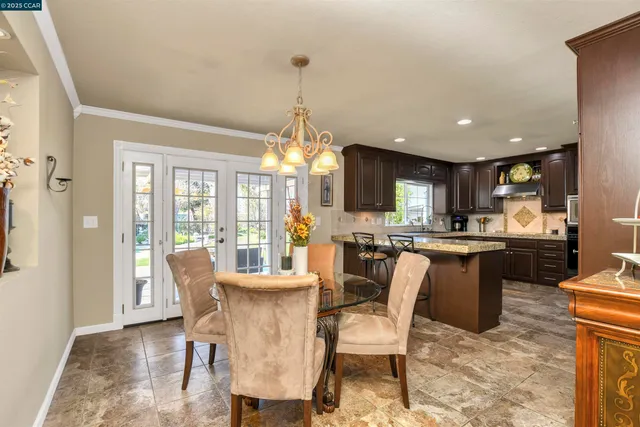 a kitchen with granite countertop stainless steel appliances a refrigerator and cabinets