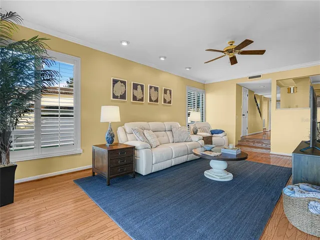 a living room with furniture kitchen view and a window