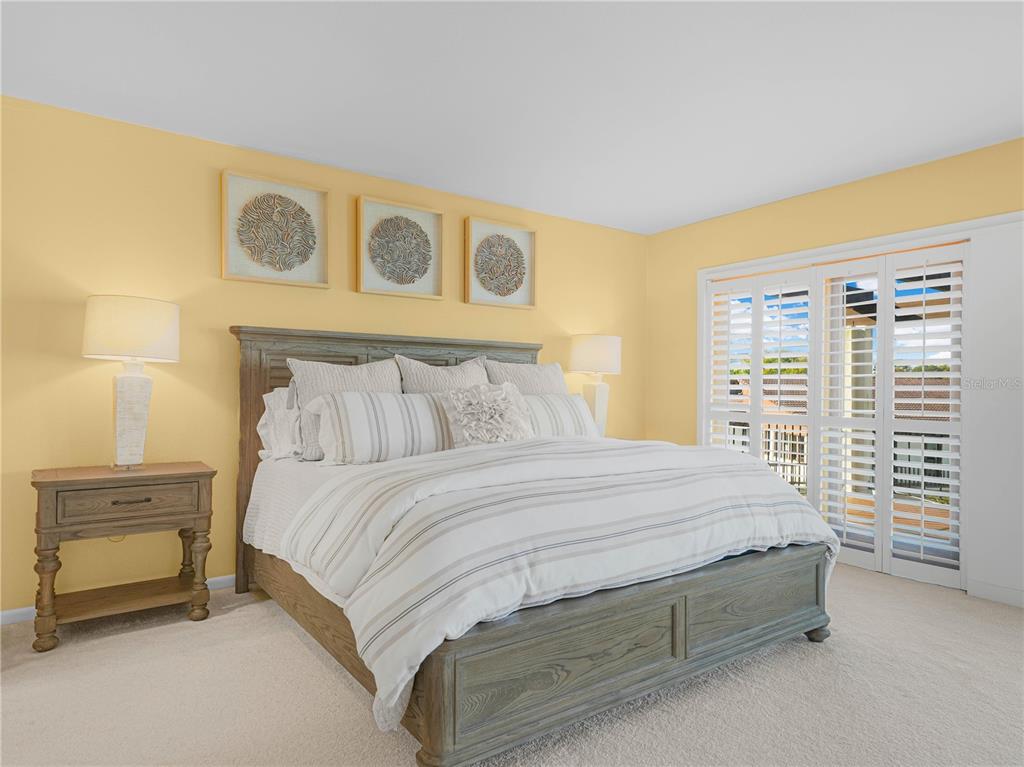 3 Casa Loma Way, Unit 3 Lakeland, FL 33813 - Photo 15 of 45 a bedroom with a bed and a table