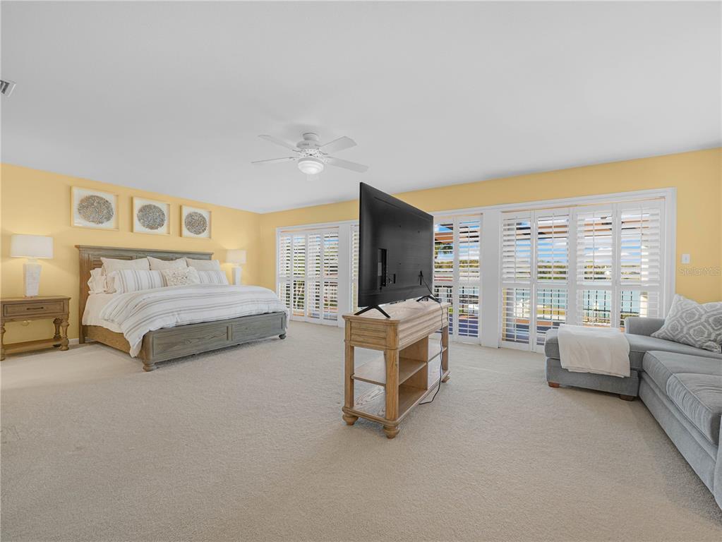 3 Casa Loma Way, Unit 3 Lakeland, FL 33813 - Photo 16 of 45 a spacious bedroom with a bed couch and a large window