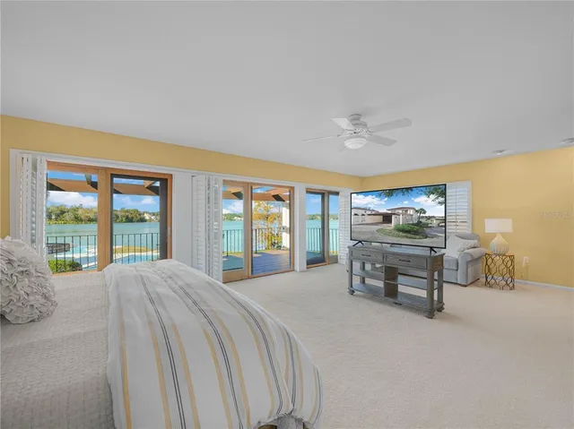 a spacious bedroom with a bed and a large window