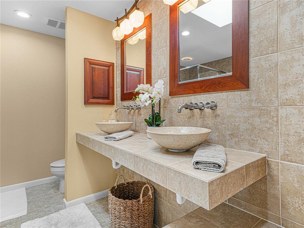 3 Casa Loma Way, Unit 3 Lakeland, FL 33813 - Photo 21 of 45 a view of a bathroom with a sink and mirror