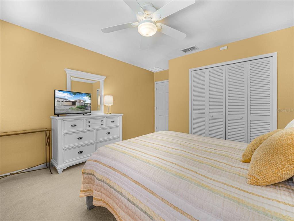 3 Casa Loma Way, Unit 3 Lakeland, FL 33813 - Photo 26 of 45 a bedroom with a bed and a dresser