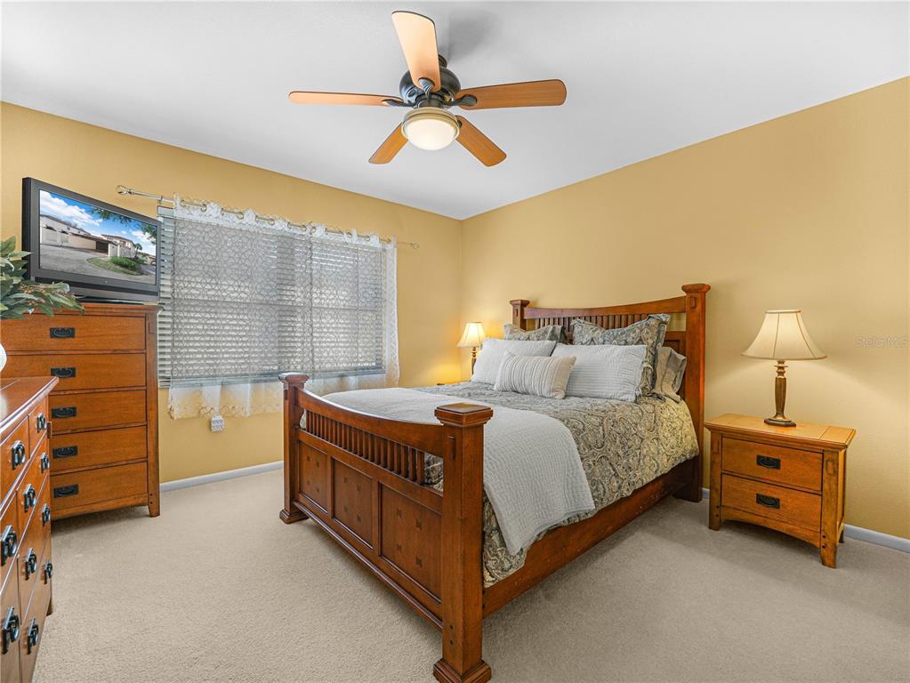 3 Casa Loma Way, Unit 3 Lakeland, FL 33813 - Photo 27 of 45 a bedroom with a bed and a dresser