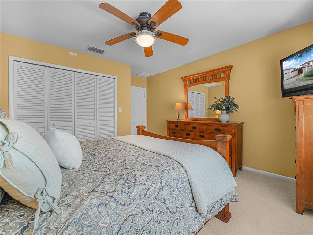 3 Casa Loma Way, Unit 3 Lakeland, FL 33813 - Photo 28 of 45 a bedroom with a large bed and a chandelier