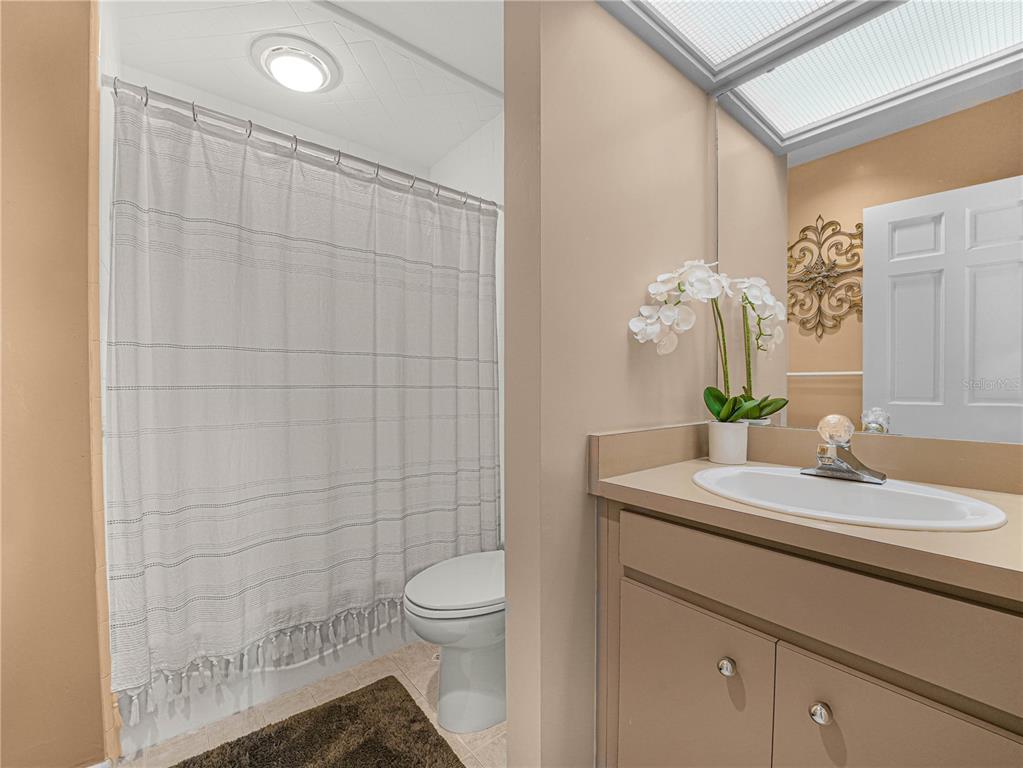 3 Casa Loma Way, Unit 3 Lakeland, FL 33813 - Photo 29 of 45 a bathroom with a sink a toilet and shower