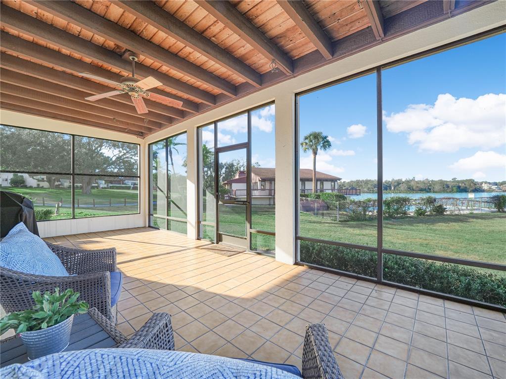 3 Casa Loma Way, Unit 3 Lakeland, FL 33813 - Photo 31 of 45 a bedroom with furniture and large windows