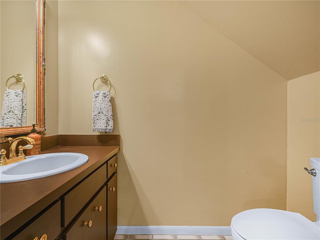 3 Casa Loma Way, Unit 3 Lakeland, FL 33813 - Photo 5 of 45 a bathroom with a sink and a mirror