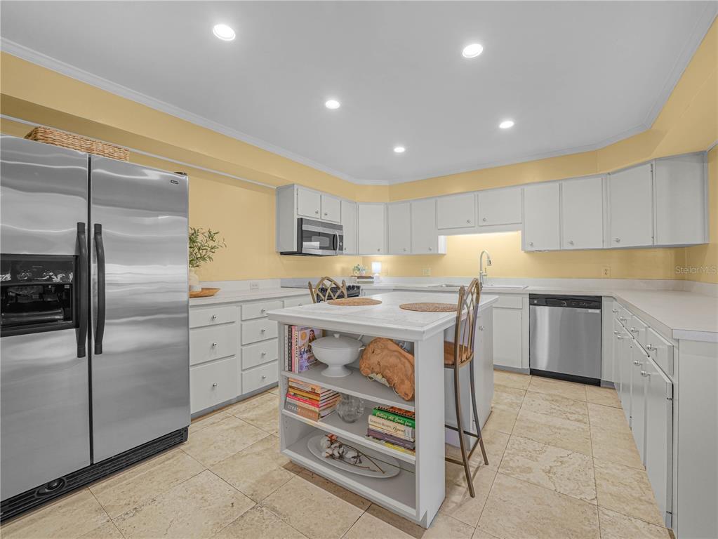 3 Casa Loma Way, Unit 3 Lakeland, FL 33813 - Photo 6 of 45 a kitchen with a refrigerator a sink and cabinets