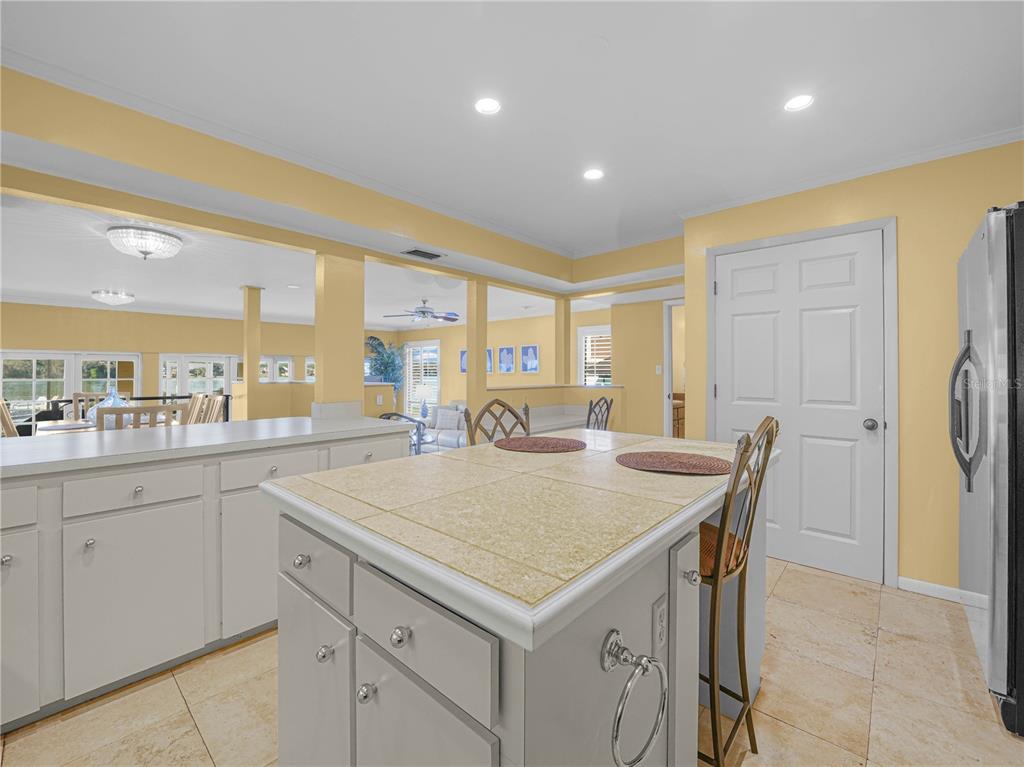 3 Casa Loma Way, Unit 3 Lakeland, FL 33813 - Photo 7 of 45 a large kitchen with kitchen island a sink table and chairs