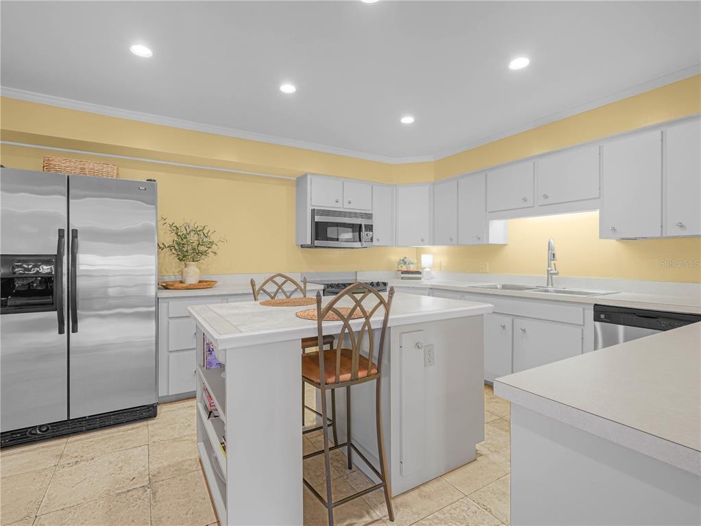3 Casa Loma Way, Unit 3 Lakeland, FL 33813 - Photo 8 of 45 a kitchen with a refrigerator and a sink