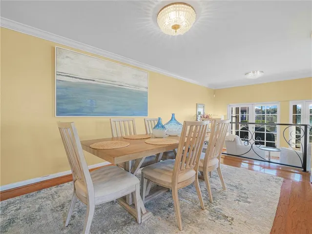 a dining room with furniture and wooden floor
