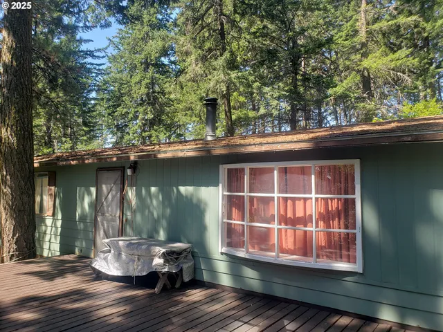 a backyard of a house with table and chairs