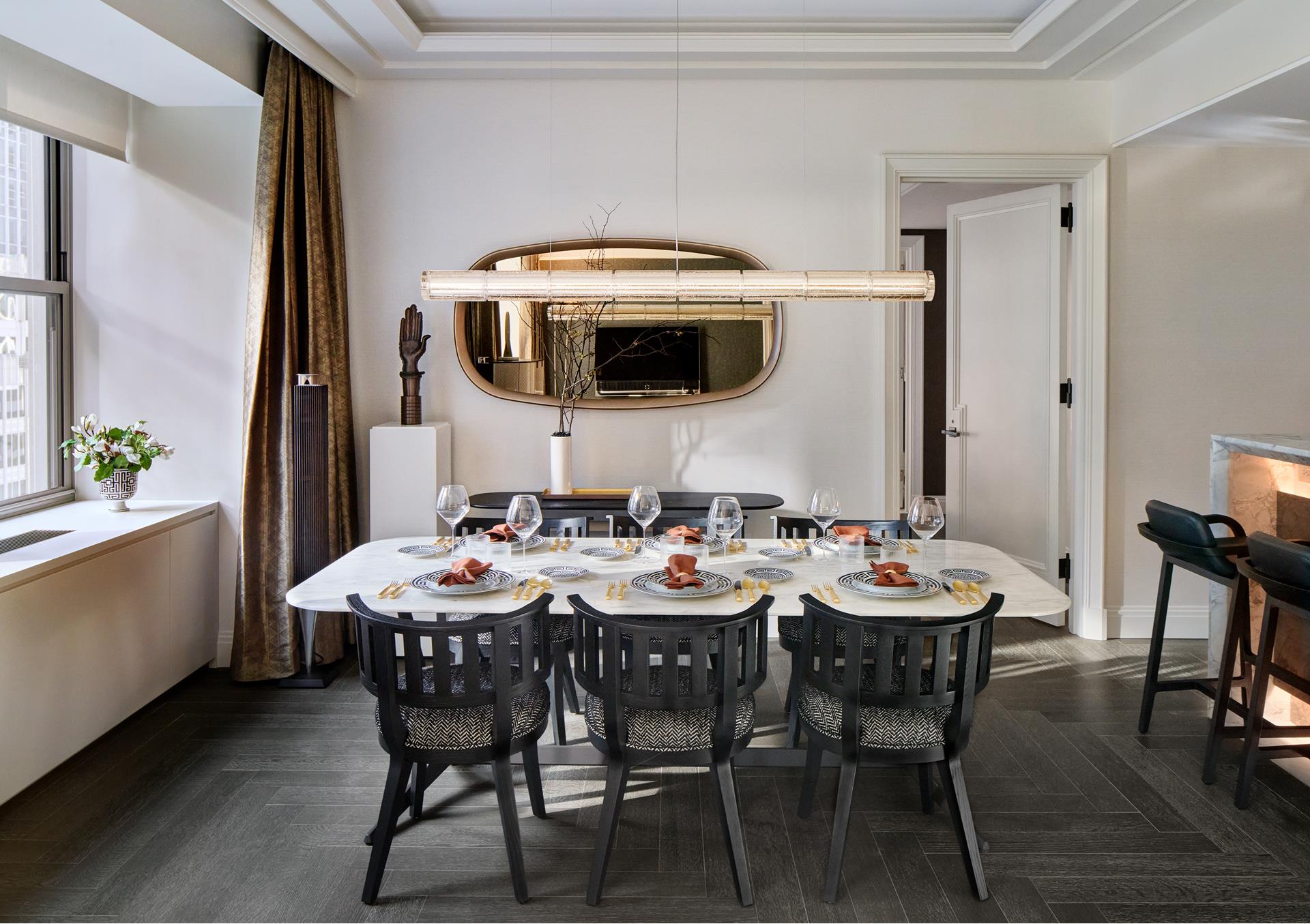 303 Park Avenue, Unit 2022 Manhattan, NY 10022 - Photo 2 of 27 a view of a dining room that has a table and chairs