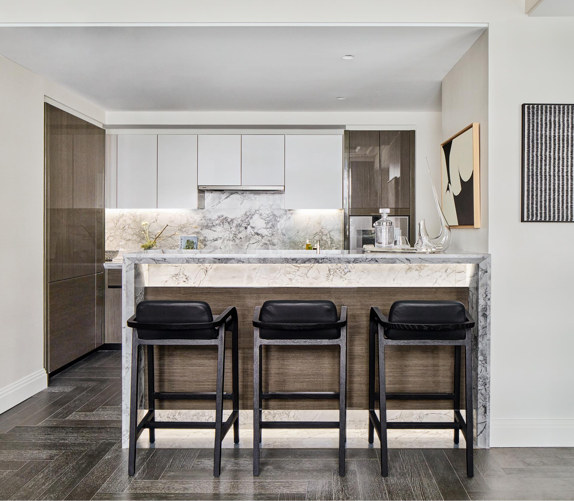 303 Park Avenue, Unit 2022 Manhattan, NY 10022 - Photo 3 of 27 a kitchen with a table and chairs in it