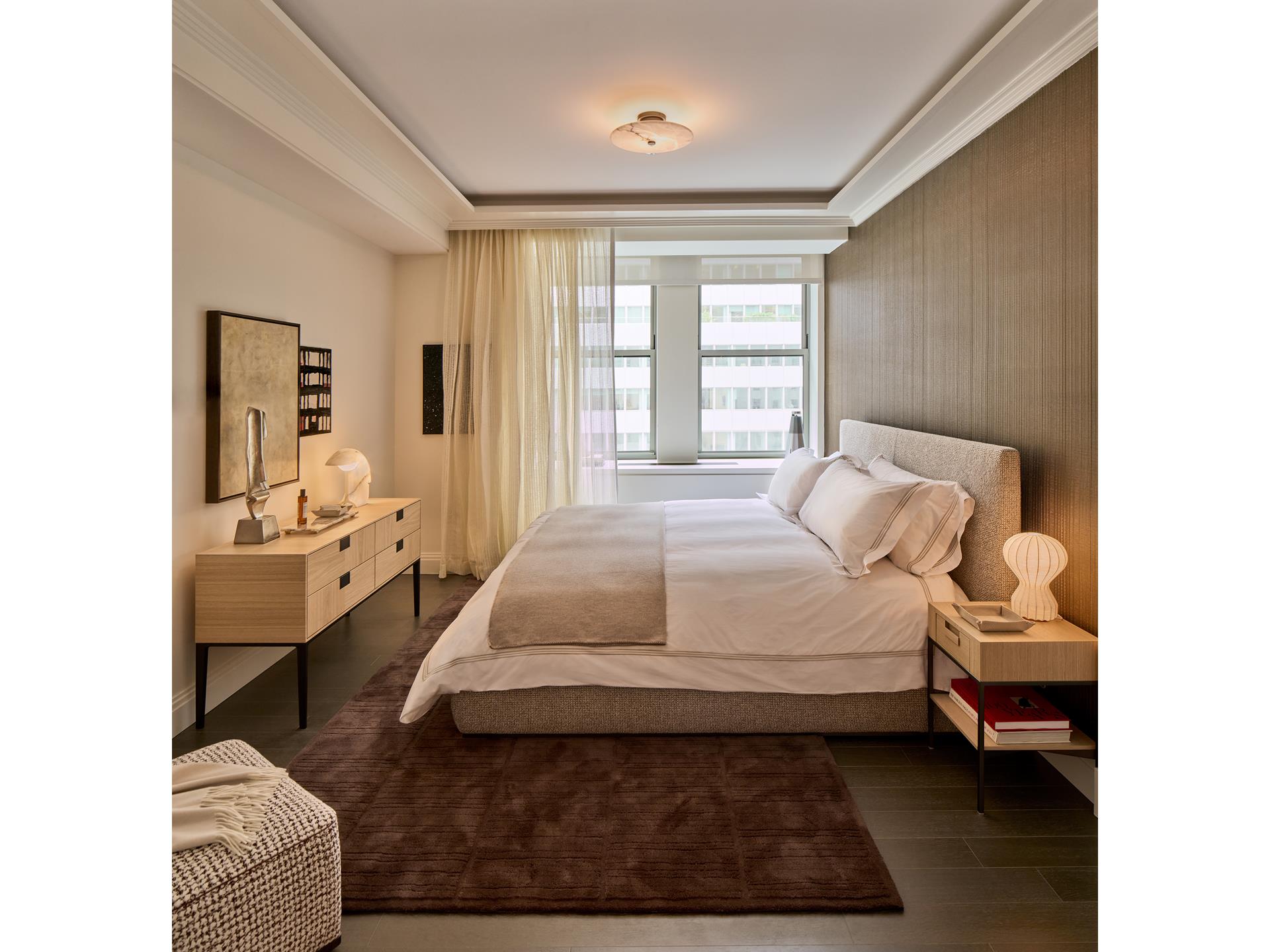 303 Park Avenue, Unit 2022 Manhattan, NY 10022 - Photo 5 of 27 a bedroom with a bed couch and a view of living room