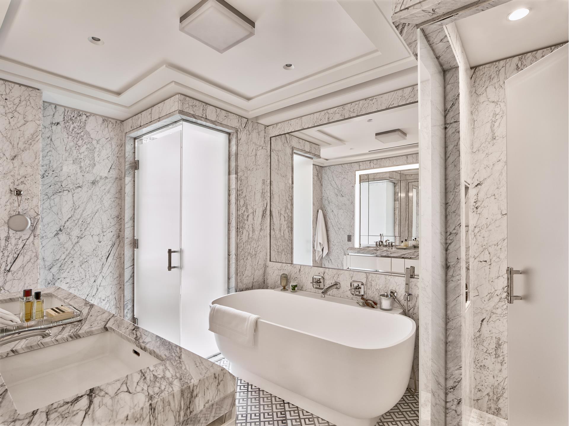 303 Park Avenue, Unit 2022 Manhattan, NY 10022 - Photo 8 of 27 a bath room with a sink and a mirror