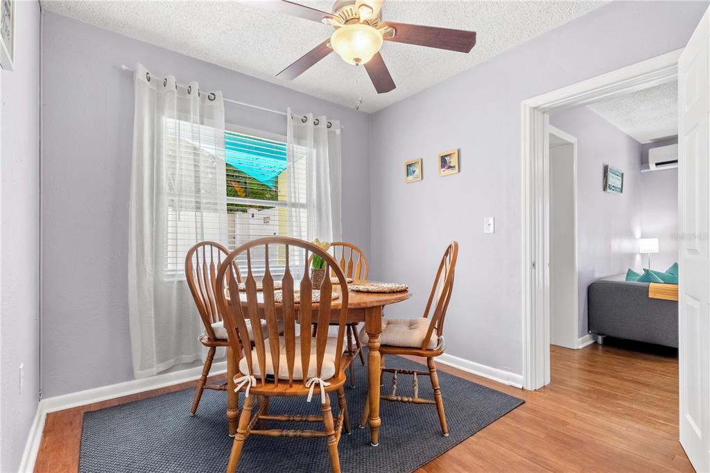 5596 100th Way North St. Petersburg, FL 33708 - Photo 12 of 67 a view of a dining room with furniture and wooden floor