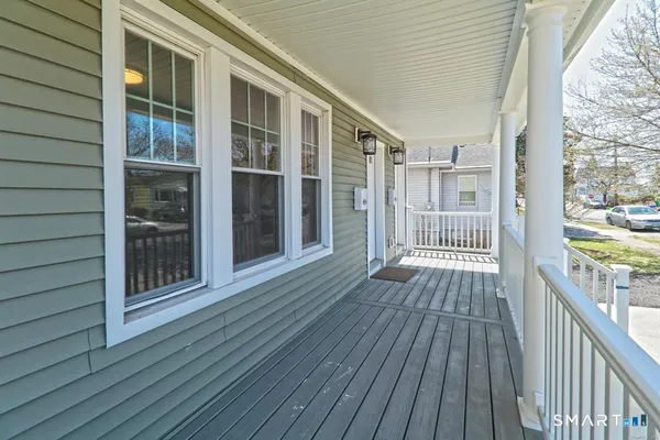 a view of a balcony with wooden floor