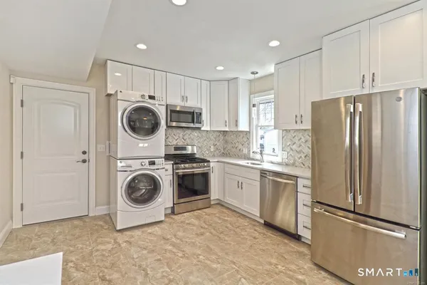 a kitchen with a refrigerator sink and cabinets