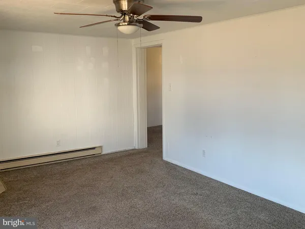 an empty room with a empty space and a ceiling fan