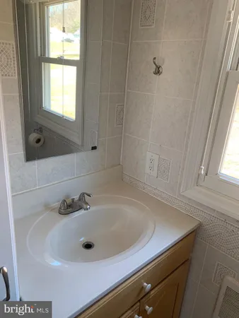 a bathroom with a sink and a window