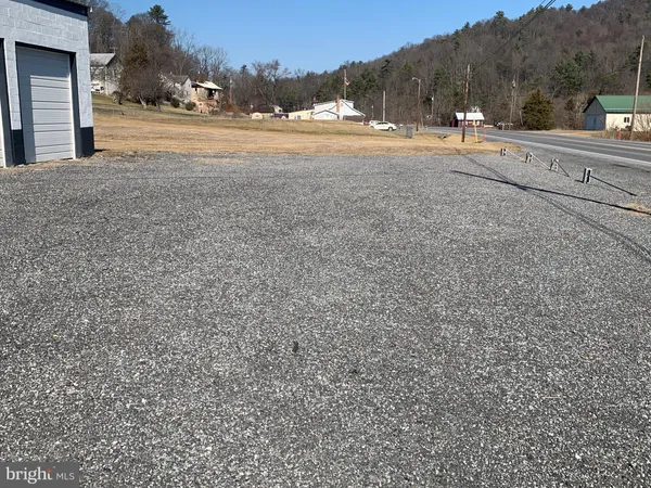 a view of dirt yard with houses