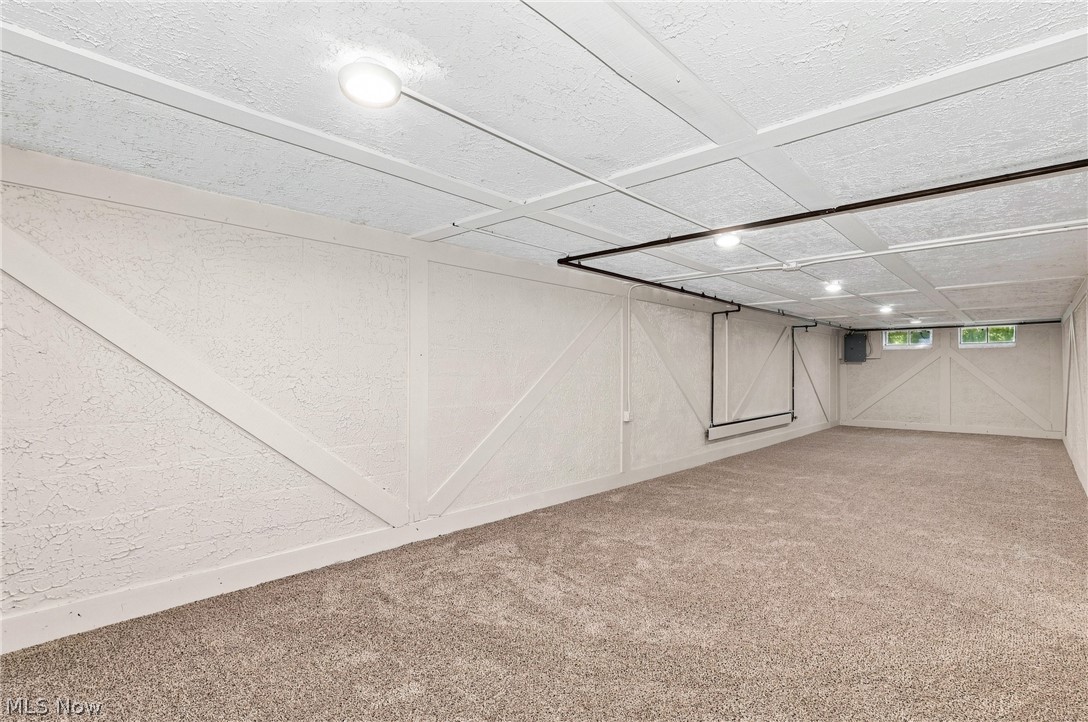 7524 Root Road North Ridgeville, OH 44039 - Photo 39 of 50 Expansive room featuring recessed lighting, paneled ceiling, textured walls with decorative trim, carpeted flooring, and multiple windows