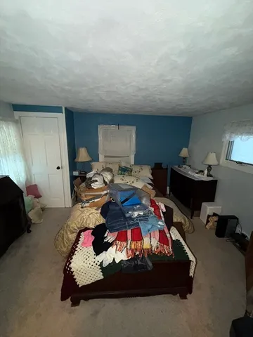 a bedroom with furniture and a chair