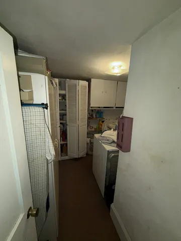 a view of a storage & utility room with refrigerator