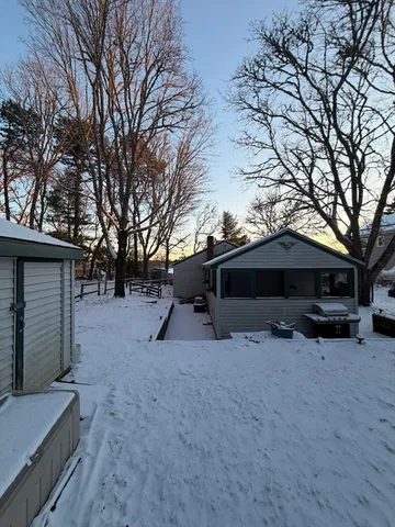 a view of house with backyard and trees
