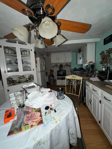 a kitchen filled with stainless steel appliances kitchen island granite countertop a sink a stove a dining table and chairs