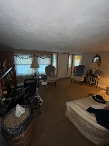 a room with gym equipment and a view of living room