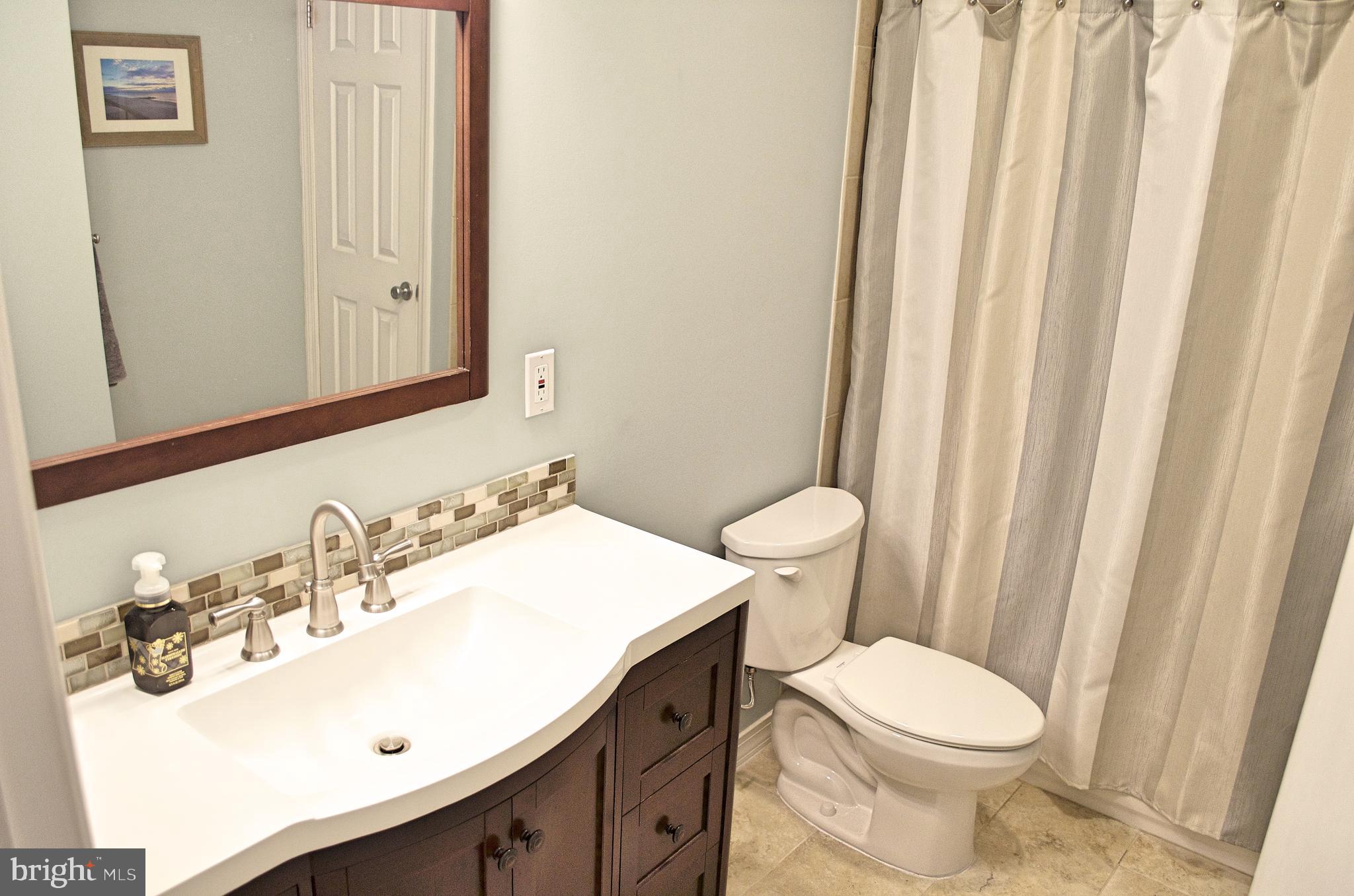 2 P Lake Drive East Windsor, NJ 08520 - Photo 6 of 11 a bathroom with a sink a toilet and shower curtain
