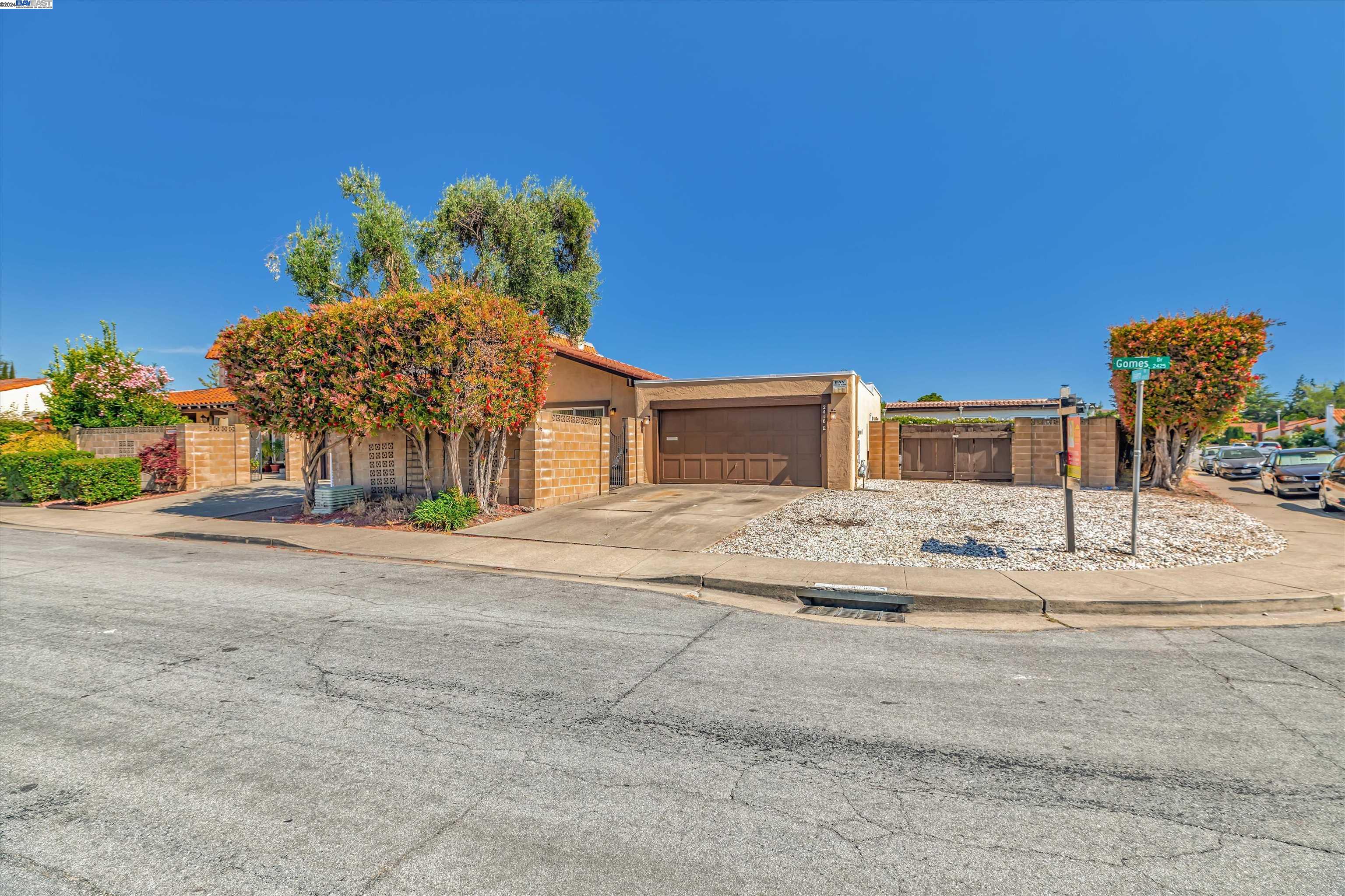 2416 Gomes Road Fremont, CA 94539 - Photo 1 of 1 a front view of a house with a yard and a garage