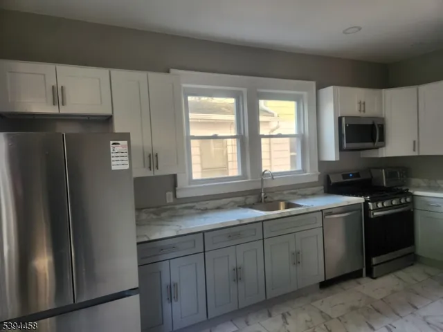 a kitchen with a sink stove and refrigerator