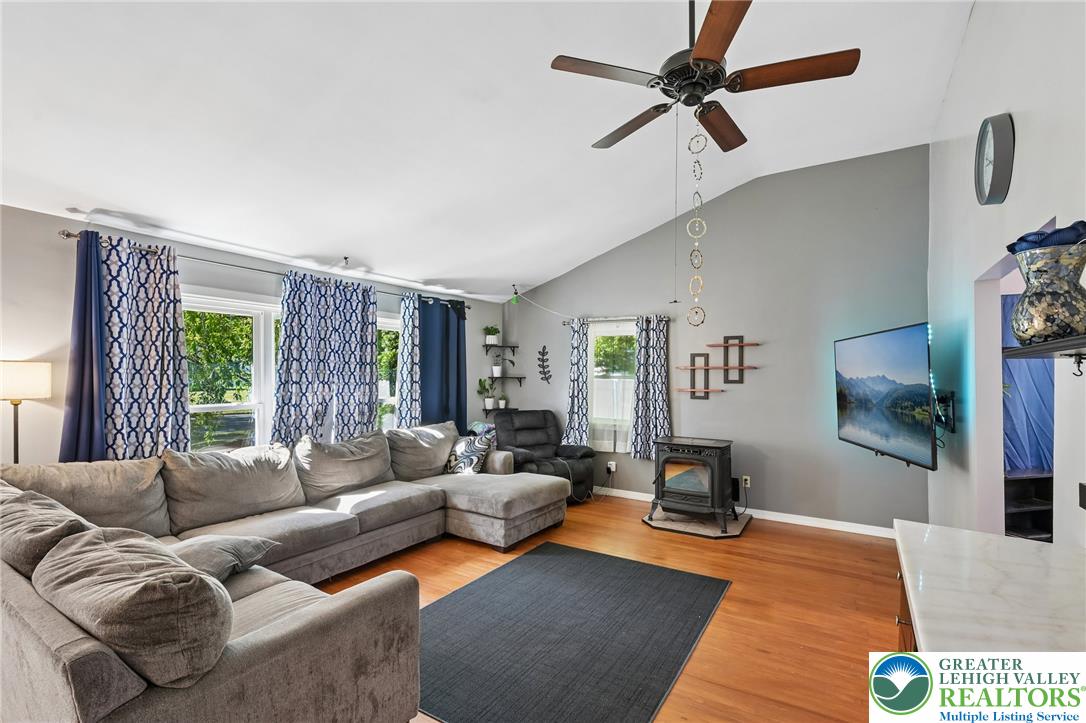 2649 Nottingham Road Bethlehem, PA 18017 - Photo 6 of 49 Hardwood floors and vaulted ceilings elevate this open-concept living space, featuring a cozy fireplace.
