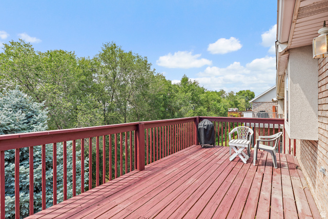 148 South Ridgeview Drive Orem, UT 84058 - Photo 20 of 23 Spacious outdoor deck with deep red wood finish, surrounded by mature trees