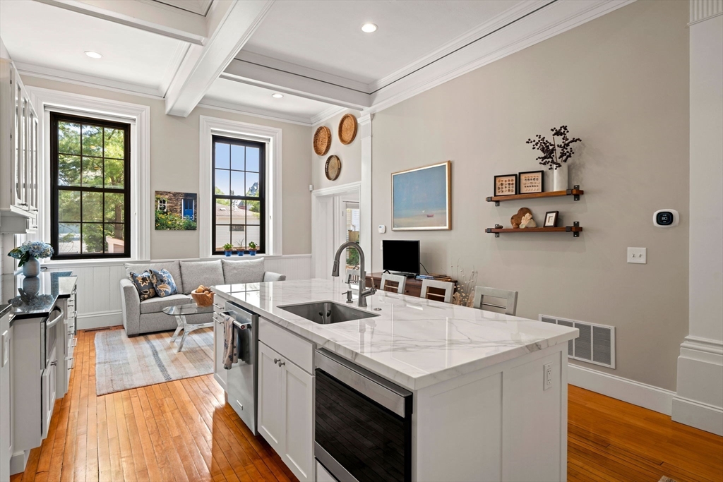 44 Pleasant Street, Unit 1 Marblehead, MA 01945 - Photo 4 of 35 a kitchen that has a sink and a stove with wooden floor