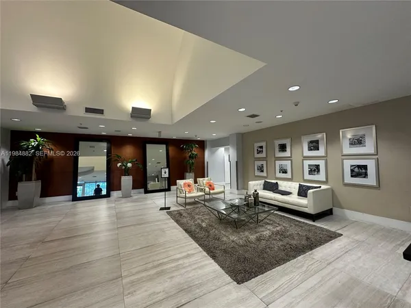 a living room with furniture and a large window
