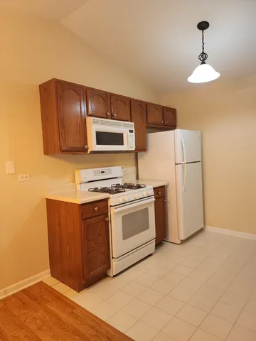 a kitchen with stainless steel appliances a refrigerator and a stove top oven