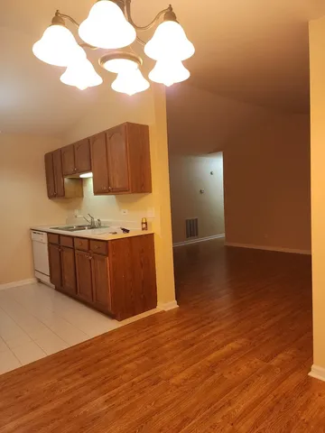a room with wooden floors and natural light