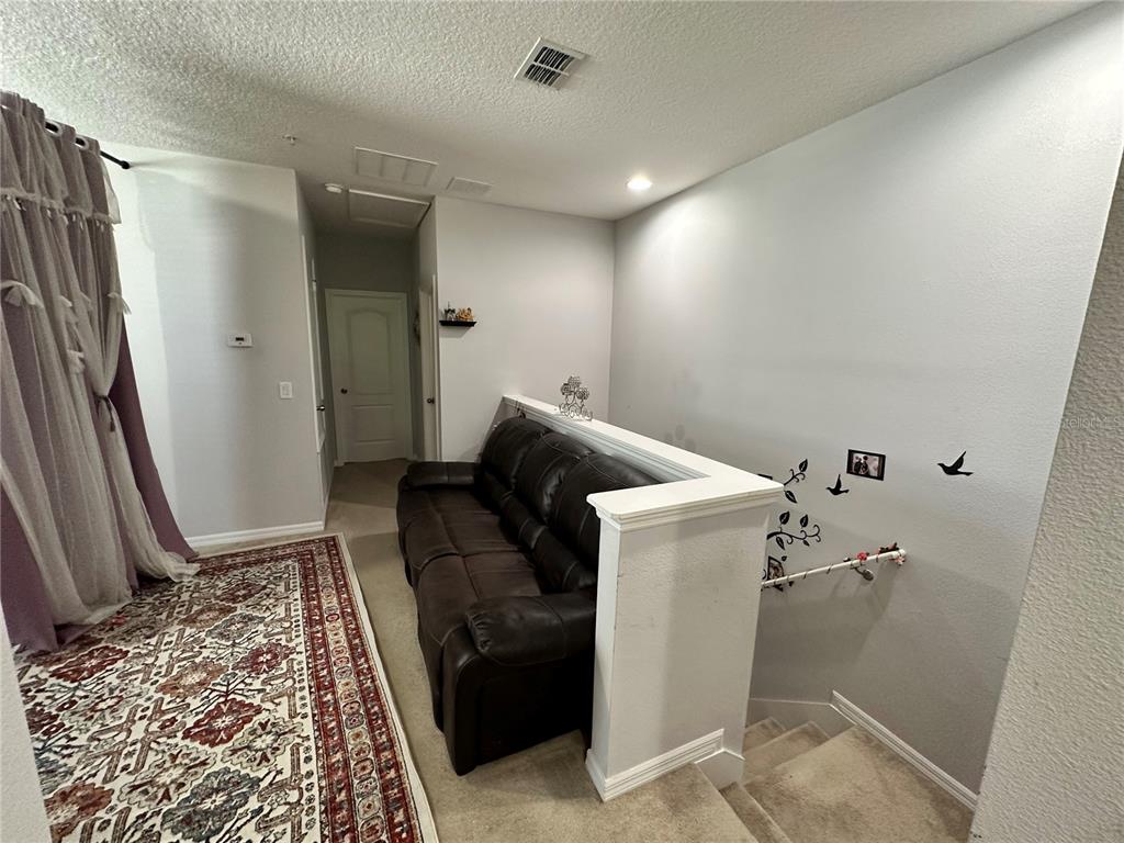 250 Rustic Loop Sanford, FL 32771 - Photo 16 of 33 a storage room with wooden floor and a rug