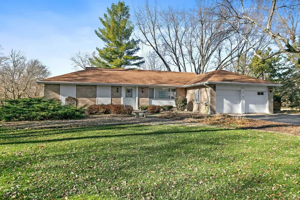 a front view of a house with a yard table and chairs