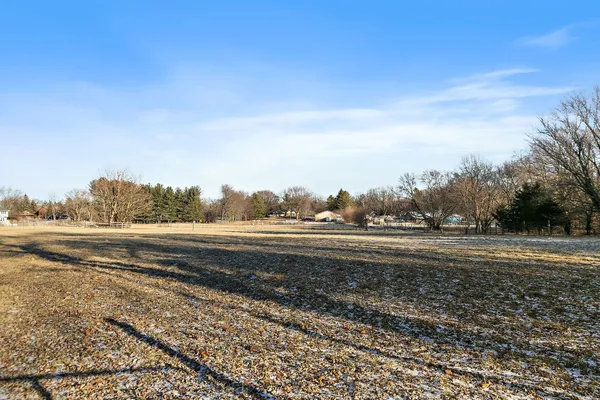 a view of a house with a yard and fence