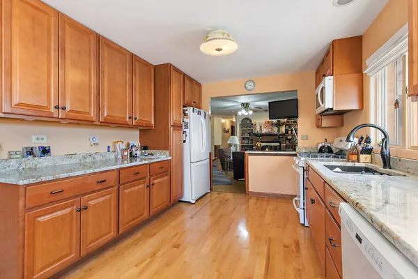 a kitchen with granite countertop a sink and cabinets
