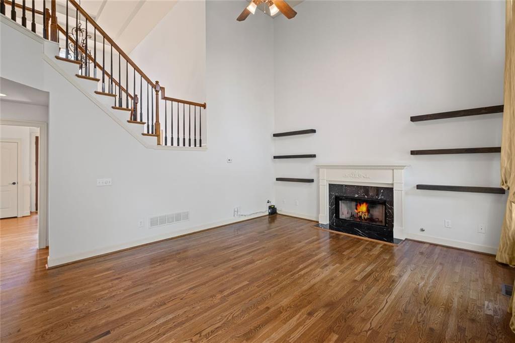 12857 Waterside Drive Alpharetta, GA 30004 - Photo 11 of 60 a view of an empty room with wooden floor fireplace and a window