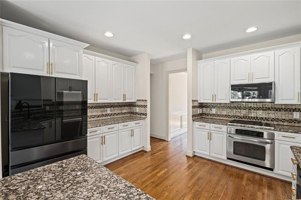 12857 Waterside Drive Alpharetta, GA 30004 - Photo 16 of 60 a kitchen with a stove and a microwave