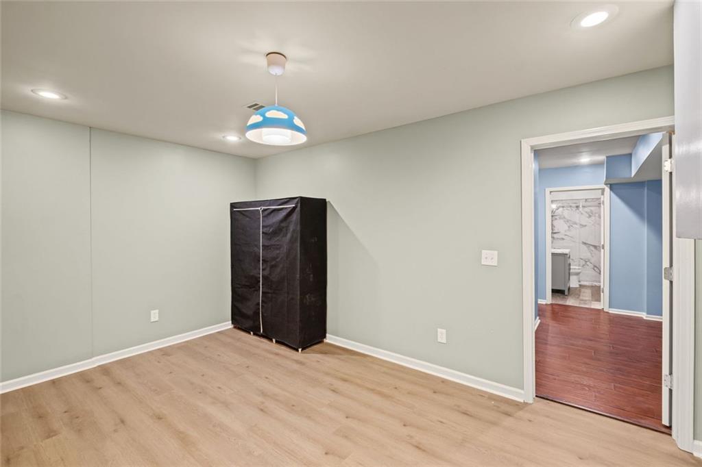 12857 Waterside Drive Alpharetta, GA 30004 - Photo 32 of 60 an empty room with cabinet and wooden floor