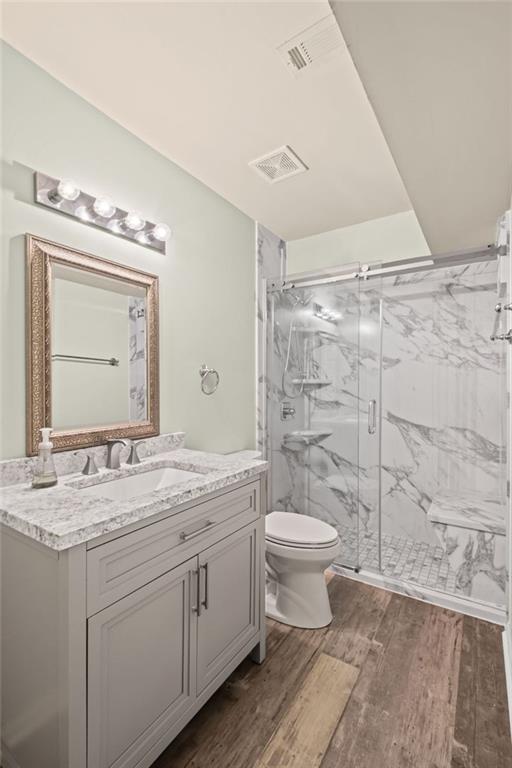 12857 Waterside Drive Alpharetta, GA 30004 - Photo 33 of 60 a bathroom with a granite countertop sink toilet a mirror and shower